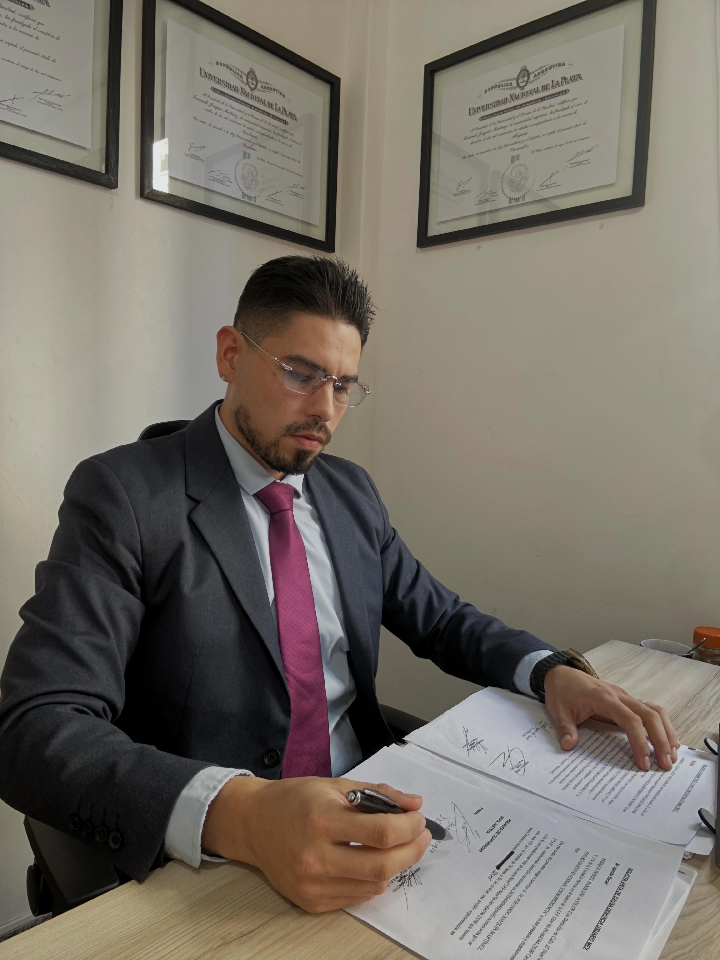 Fernando J. Martínez, abogado, firmando un expediente en su oficina de La Plata